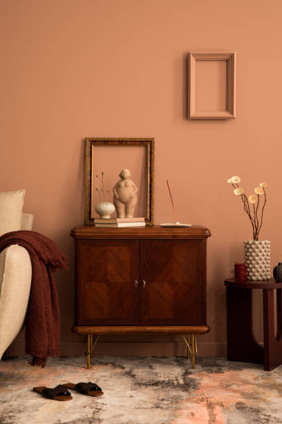istock Creative composition of living room interior with frame, wooden sideboard, beige sofa, patterned carpet, round coffee table, sculpture, plaid and personal accessories. Home decor. Template. 1466321823
