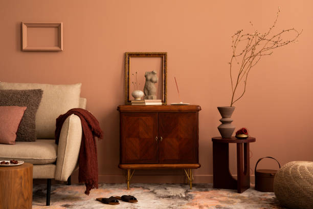 istock Interior design of living room interior with frame, wooden sideboard, beige sofa, patterned carpet, round coffee table, sculpture, plaid and personal accessories. Home decor. Template. 1466321859