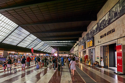 Florence, Italy - September 09, 2022: Passengers walk through the hall of the Santa Maria Novella train station in Florence.