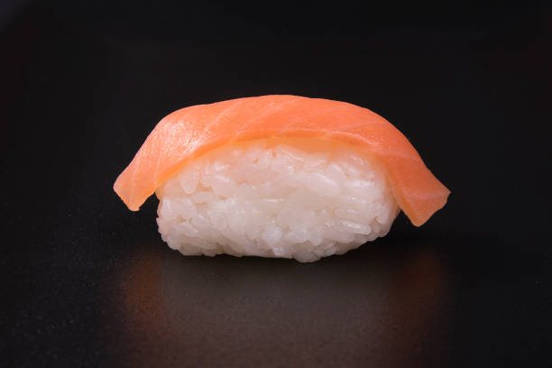 istock Closeup of salmon sashimi on a black background 1466325024