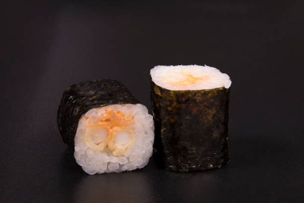 istock Closeup of classic sushi rolls on a black background 1466325082
