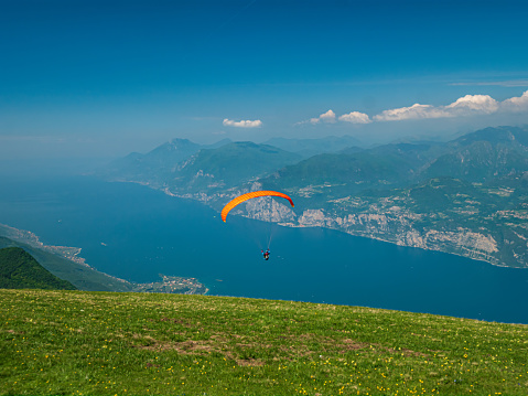 A paraglider soars over the Alps.