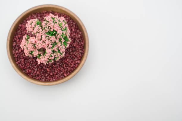 bowl filled with  plant and decorative sand on white background with space for text