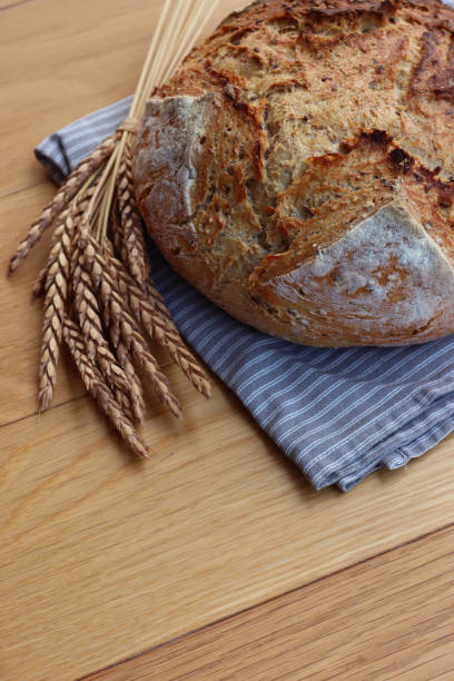 istock Wholegrain bread with spelt flour with seeds on wooden table 1466326536