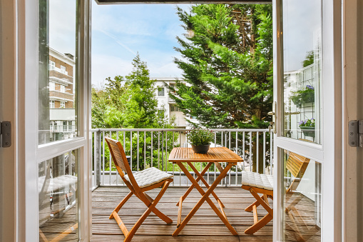 A beautiful image of a tiny outdoor balcony with a green view; design ideas