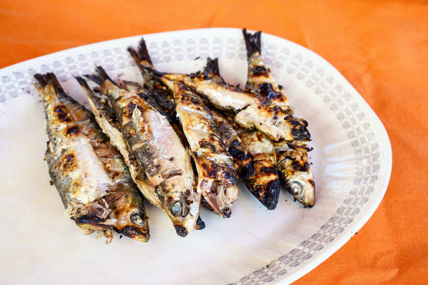 Closeup shot of a heap of grilled fish on a plate