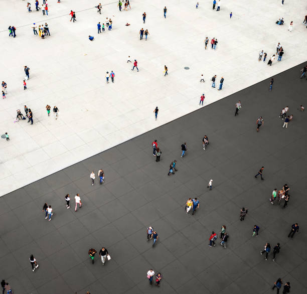 crowds standing on two separated zones - individuality standing out from the crowd contrasts competition imagens e fotografias de stock