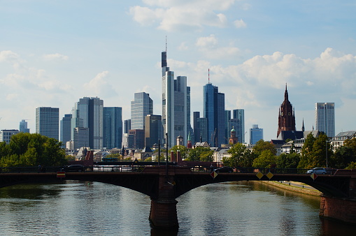 Frankfurt skyline behind the Ignatz Bubis Bridge on the River Main. Cathedral, Commerzbank and Main Tower among others.