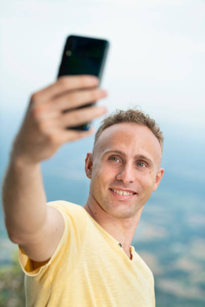 istock Young adult boy taking a selfie 1466335529