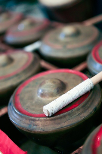 Close up of set of small brass gongs called talempong, a traditional music instrument of minangkabau culture from west sumatra, Indonesia. No people. Selective focus.
