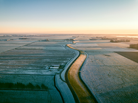 Zuiderzee levee seen from above during a winter sunset between Overijssel and Flevoland near Blokzijl.