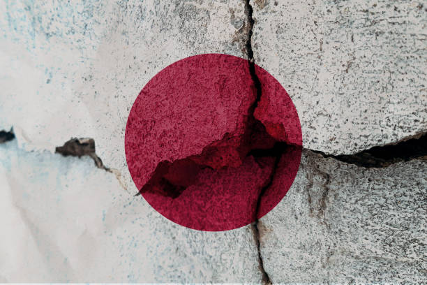 istock Japan flag on cracked wall. Earthquake or drought concept 1466336311
