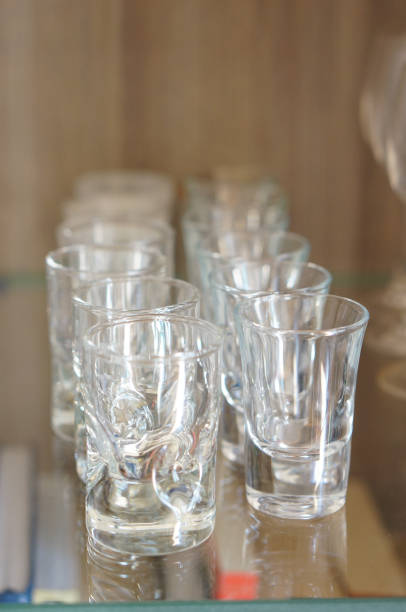 istock Rows of empty shot glass cups on a glass table 1466336791
