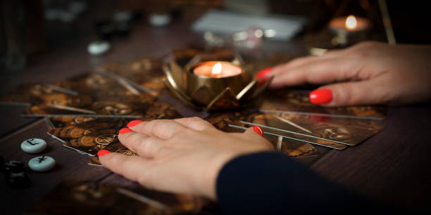 istock Defocused still Life with tarot cards. magic or fortune telling rite with occult and esoteric symbols. 1466337165