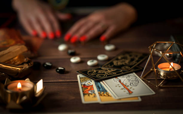 istock Blurred Fortune teller woman reading a future by tarot cards 1466337252