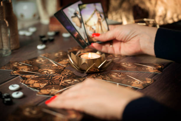 istock Blurred Fortune teller woman reading a future by tarot cards 1466337430