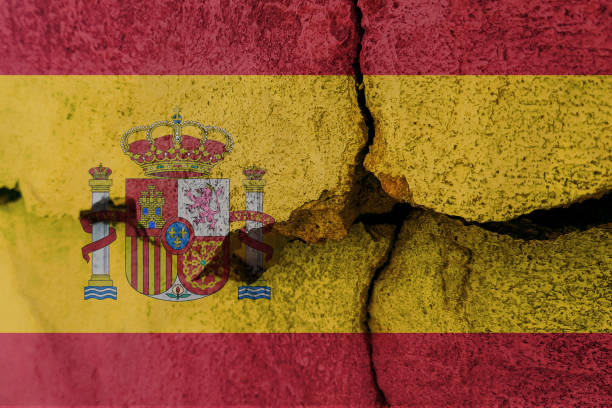 istock Spain flag on cracked wall. Earthquake or drought concept 1466339536