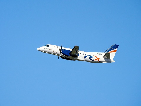 A Rex Saab 340B+ plane taking off to the north from Sydney Kingsford-Smith Airport.  The plane, VH-ZLK, flight number ZL6691, was flying to Wagga Wagga in southern inland New South Wales.   This image was taken from Tempe Recreation Reserve on a sunny afternoon on 15 February 2023.