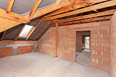 Unfinished construction inside red brick house not plastered
