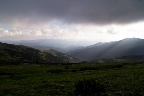istock Low lying rain clouds above hill landscape photo 1466347764