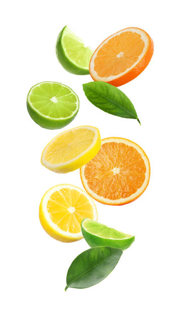 Different fresh citrus fruits and leaves falling on white background