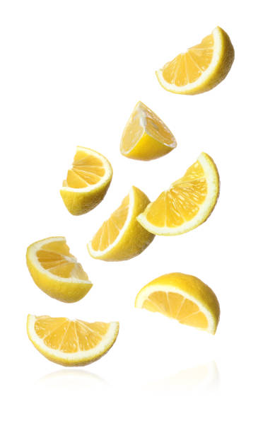 istock Fresh ripe lemon slices falling on white background 1466349105
