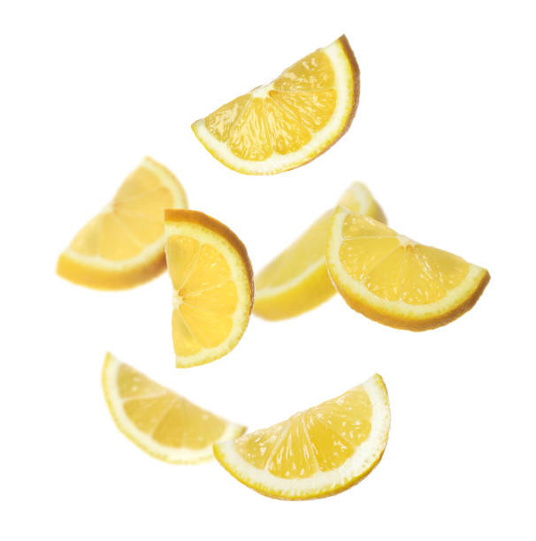 istock Fresh ripe lemon slices flying on white background 1466349106