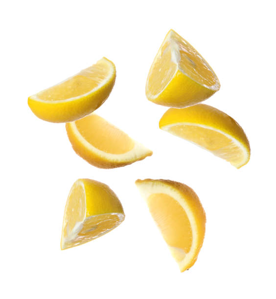 istock Fresh ripe lemon slices falling on white background 1466349217