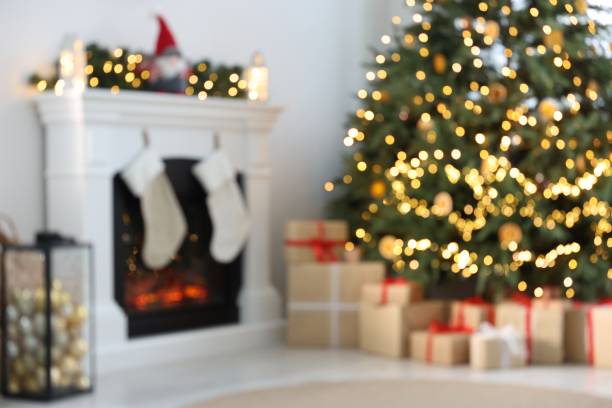 istock Blurred view of many different gift boxes under Christmas tree and festive decor in living room 1466349253