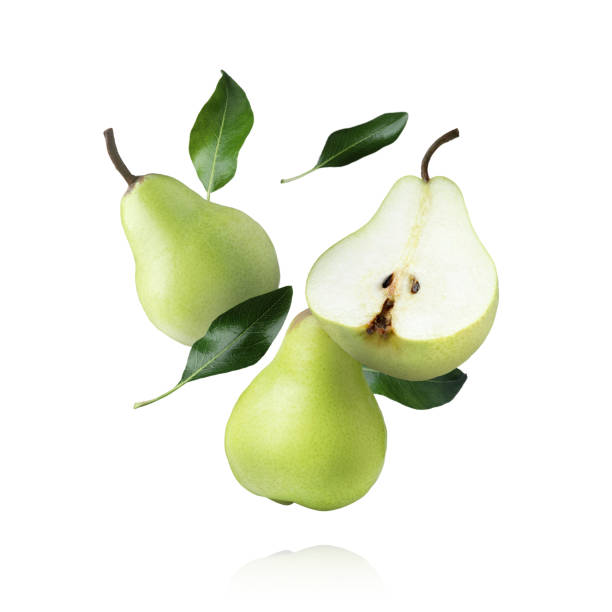 istock Fresh ripe pears and green leaves falling on white background 1466349856