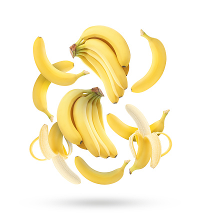 Delicious ripe banana fruits falling on white background