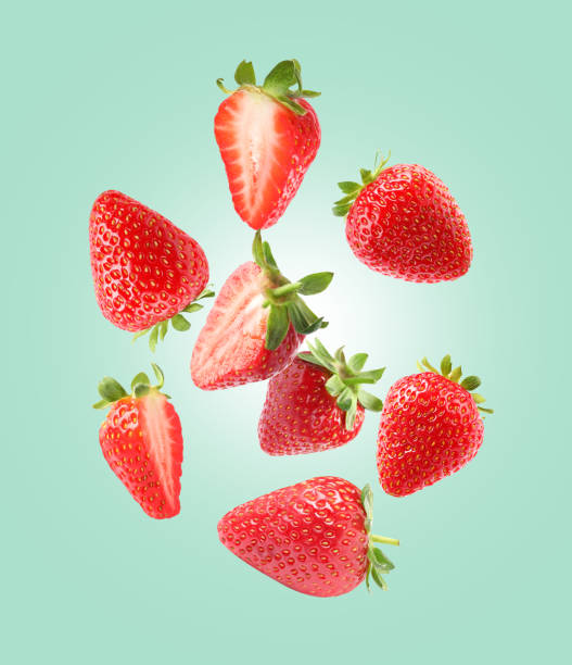 istock Delicious sweet strawberries falling on pale turquoise background 1466350249