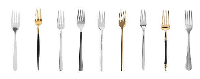 Set of shiny forks on white background