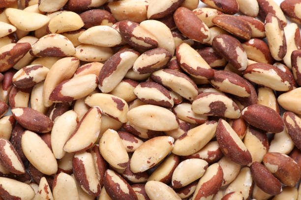istock Many delicious Brazil nuts as background, top view 1466351415