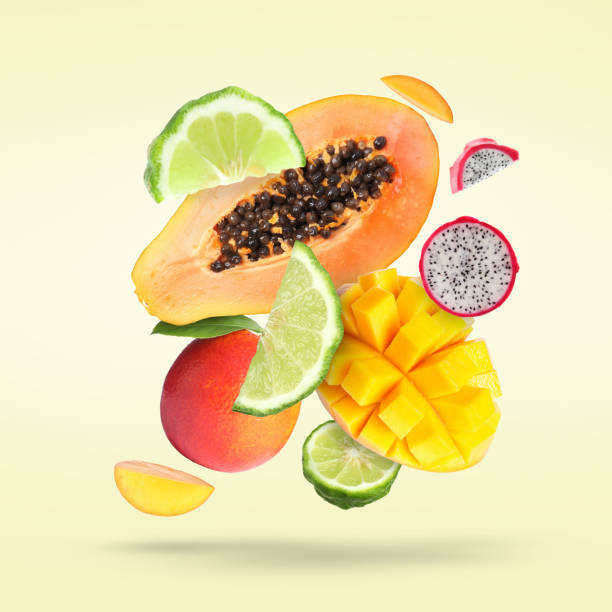 istock Many fresh tropical fruits falling on light pale yellow background 1466351597