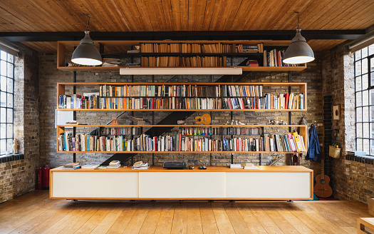 Library bookshelves in modern warehouse loft conversion