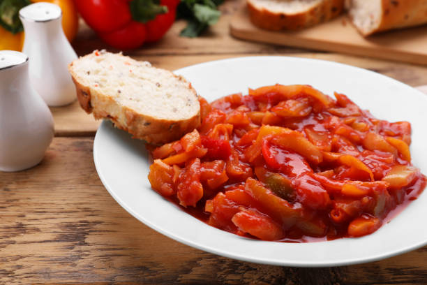 istock Delicious lecho with bread on wooden table, closeup 1466351832
