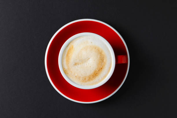 istock Cup with aromatic cappuccino on black background, top view 1466352103