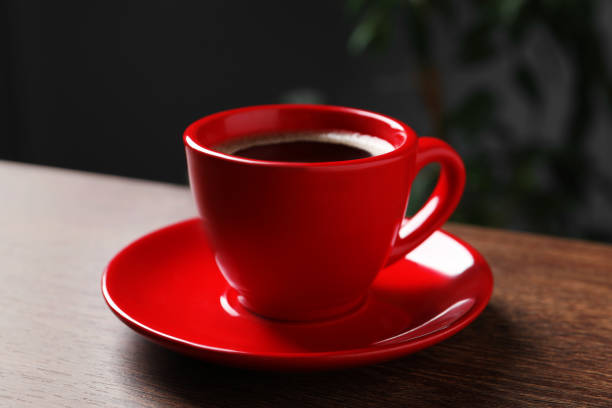 istock Red cup with aromatic coffee on wooden table indoors, closeup 1466352127