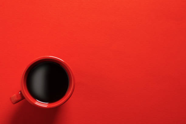 istock Cup with aromatic coffee on red background, top view. Space for text 1466352313
