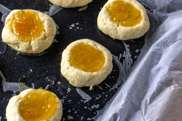 istock Half cooked jam filled thumb print cookies on a baking tray with copy space 1466353703