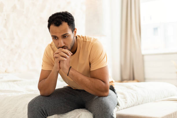 istock Depressed Middle Eastern Man Sitting Thinking In Modern Bedroom 1466358434