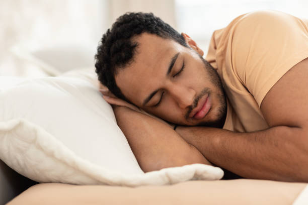 istock Arabic Man Napping Holding Hands Behind Head Sleeping In Bedroom 1466358477