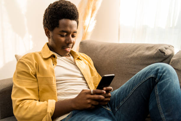 istock Young African American man using mobile phone. 1466359505
