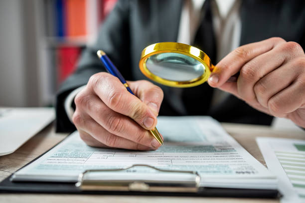 istock businessman looking 1040 blank tax form using magnifying glass at office 1466360358