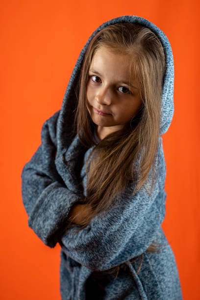 istock girl in a gray robe and a smile isolated on a plain background in the studio. 1466361145
