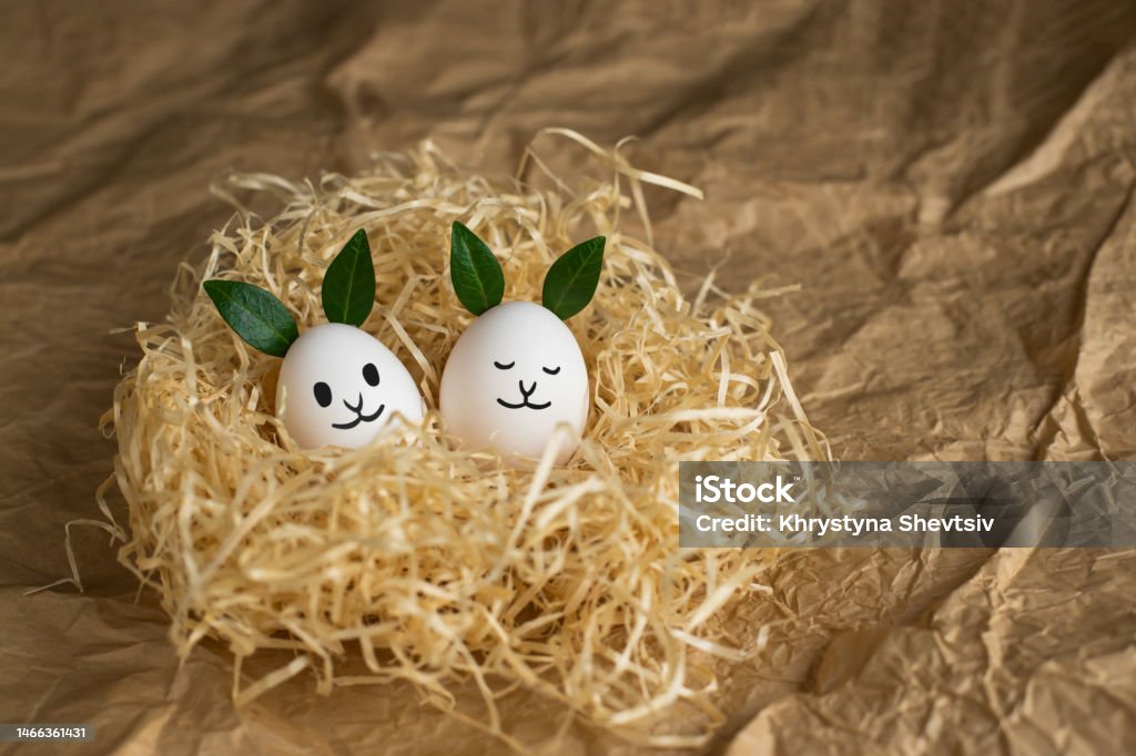 https://media.istockphoto.com/id/1466361431/photo/fancy-white-easter-eggs-with-funny-green-bunny-ears-in-straw-nest-on-brown-paper-background.jpg?s=1024x1024&w=is&k=20&c=z0JalKySZUKQB2hKMmYaliGcADFTUpDcH_yWL-52PWc=