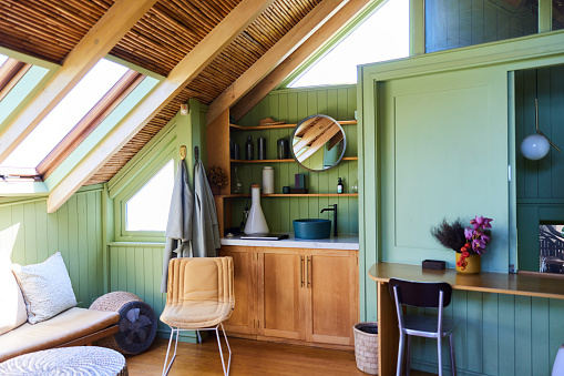 Bright and comfortable living area in a vacation home with rustic green wood-paneled walls