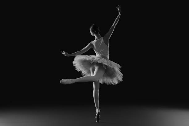 istock Young ballerina practicing dance moves. Black and white effect 1466363177
