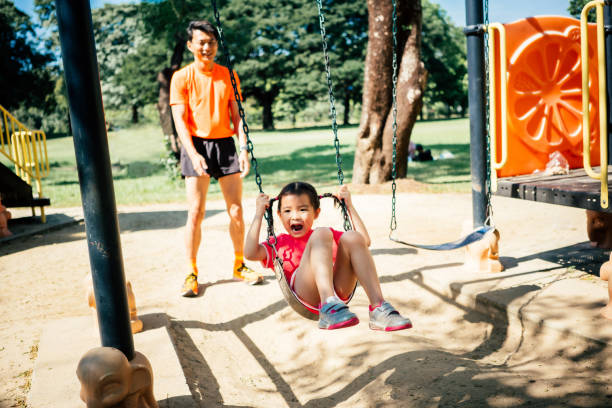 istock Asian little girl having fun swinging 1466363354